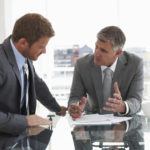 Negotiation Mastery: A Guide for Technical Experts Two men at a meeting table - a one-to-one coaching session